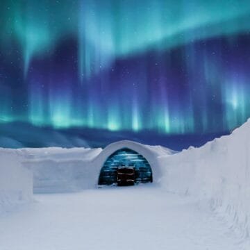 ice sculpture in the snow under northern lights in Lapland