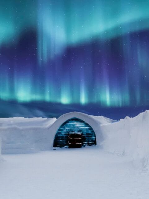 ice sculpture in the snow under northern lights in Lapland